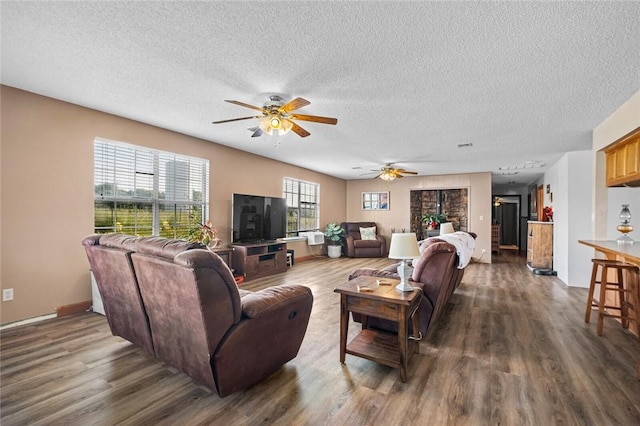 13183 Shady Grove Rd, Gravette, AR 72736 - living room featuring dark wood-style floors, ceiling fan, and a textured ceiling