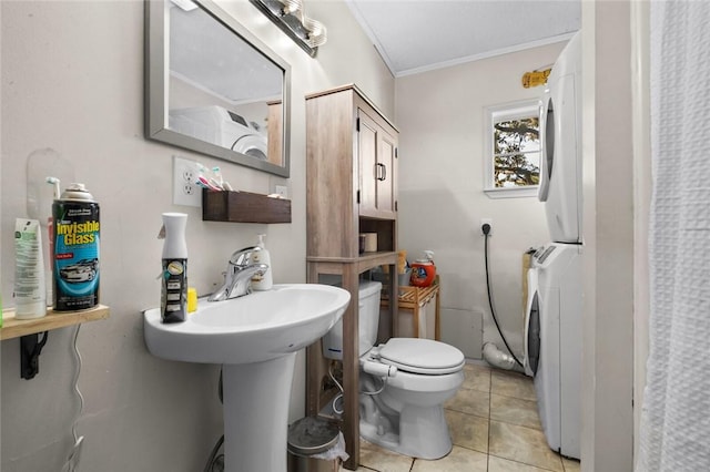 13183 Shady Grove Rd, Gravette, AR 72736 - bathroom featuring estacked washer and dryer, ornamental molding, and tile patterned floors