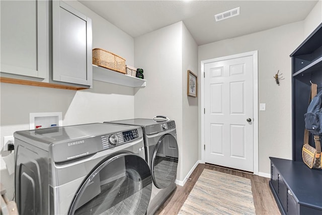 3461 Red Tail Way, Farmington, AR 72730 - laundry room featuring cabinet space, independent washer and dryer, and wood finished floors