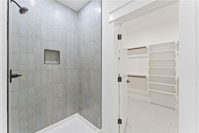 17 Westmorland Dr, Bella Vista, AR 72714 - bathroom with a tile shower, tile patterned flooring, and a spacious closet