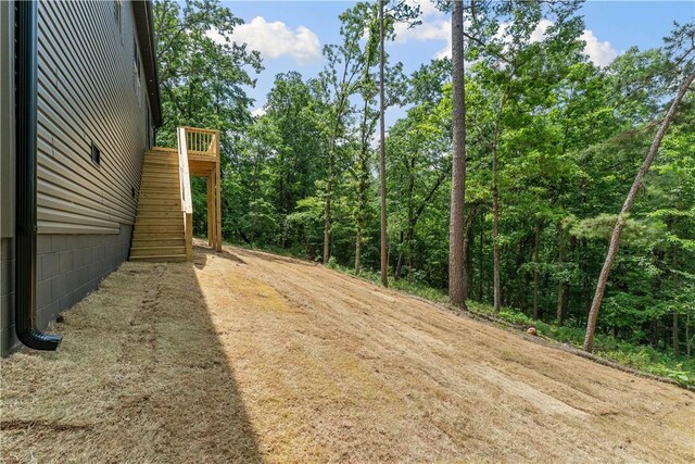 17 Westmorland Dr, Bella Vista, AR 72714 - view of yard featuring stairs and a forest view