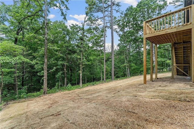 17 Westmorland Dr, Bella Vista, AR 72714 - view of yard with stairs, a deck, and a wooded view