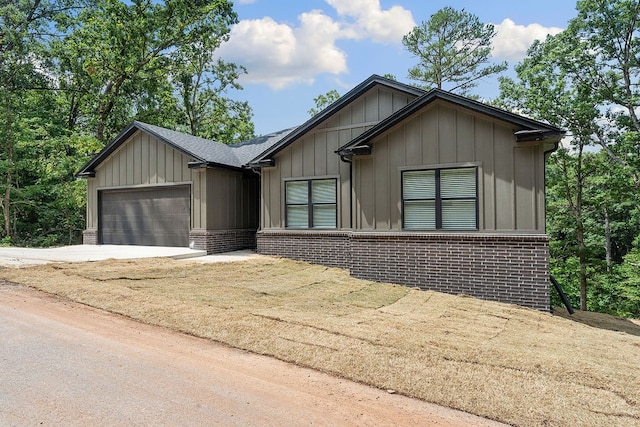 17 Westmorland Dr, Bella Vista, AR 72714 - view of front facade with brick siding, a garage, concrete driveway, and board and batten siding