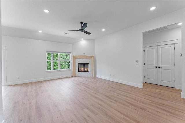 17 Westmorland Dr, Bella Vista, AR 72714 - unfurnished living room featuring a ceiling fan, light wood-type flooring, recessed lighting, and a tile fireplace