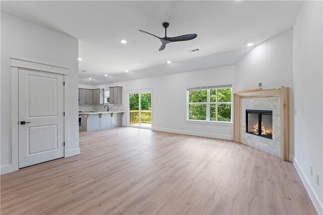 17 Westmorland Dr, Bella Vista, AR 72714 - unfurnished living room with ceiling fan, light wood finished floors, a fireplace, and recessed lighting