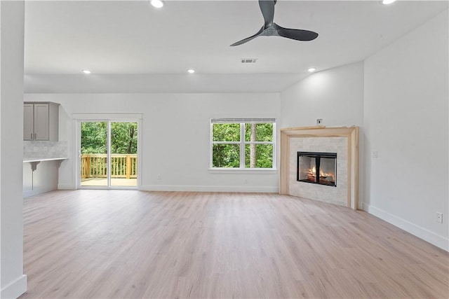 17 Westmorland Dr, Bella Vista, AR 72714 - unfurnished living room with healthy amount of natural light, light wood finished floors, recessed lighting, a fireplace, and a ceiling fan