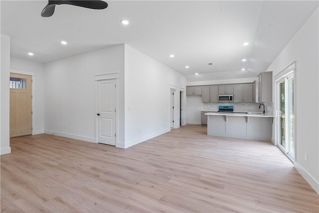17 Westmorland Dr, Bella Vista, AR 72714 - kitchen featuring stainless steel microwave, gray cabinetry, light wood-type flooring, light countertops, and recessed lighting