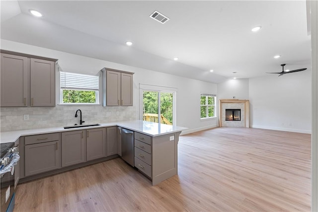 17 Westmorland Dr, Bella Vista, AR 72714 - kitchen with stainless steel appliances, a peninsula, gray cabinets, light wood-type flooring, and recessed lighting