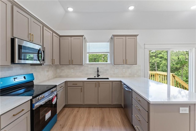 17 Westmorland Dr, Bella Vista, AR 72714 - kitchen featuring appliances with stainless steel finishes, a peninsula, gray cabinets, light wood-type flooring, and recessed lighting