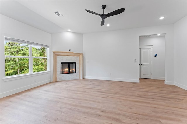 17 Westmorland Dr, Bella Vista, AR 72714 - unfurnished living room featuring ceiling fan, light wood-style floors, a tiled fireplace, and recessed lighting