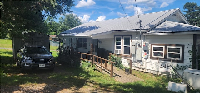 204 Glade St, Marshall, AR 72650 - rear view of house featuring a metal roof, a shed, oil tank, cooling unit, and a detached carport