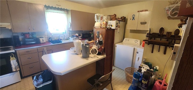 204 Glade St, Marshall, AR 72650 - kitchen featuring washing machine and clothes dryer, light flooring, range, range hood, and light countertops