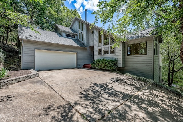 2855 E Hyland Park Rd, Fayetteville, AR 72701 - mid-century home featuring concrete driveway, a garage, and roof with shingles