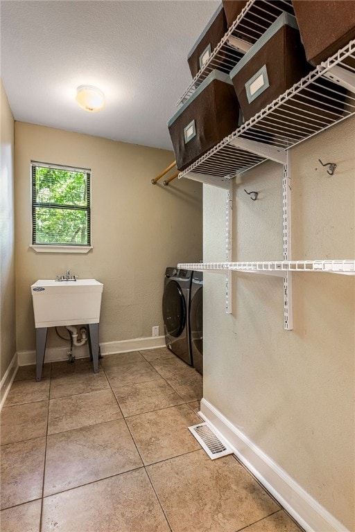 2855 E Hyland Park Rd, Fayetteville, AR 72701 - laundry room with washer and dryer and tile patterned floors
