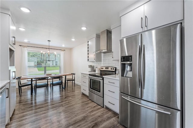 2905 NE 12th St, Bentonville, AR 72712 - kitchen with appliances with stainless steel finishes, wall chimney range hood, light countertops, dark wood-type flooring, and white cabinets