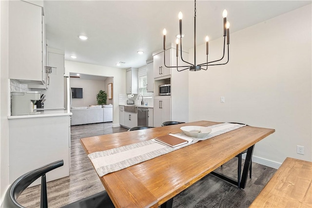 2905 NE 12th St, Bentonville, AR 72712 - dining room with a chandelier, wood finished floors, and recessed lighting
