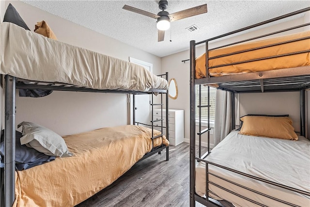 2905 NE 12th St, Bentonville, AR 72712 - bedroom featuring wood finished floors, a textured ceiling, and ceiling fan