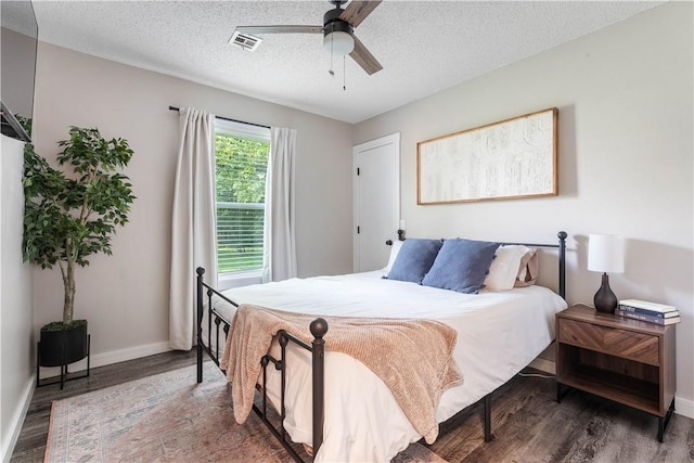2905 NE 12th St, Bentonville, AR 72712 - bedroom with wood finished floors, a textured ceiling, and ceiling fan