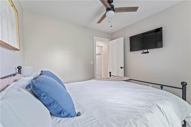 2905 NE 12th St, Bentonville, AR 72712 - bedroom with ceiling fan and a textured ceiling