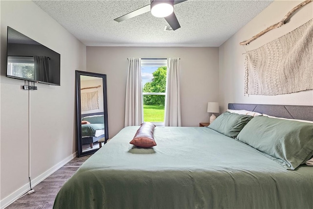 2905 NE 12th St, Bentonville, AR 72712 - bedroom with wood finished floors, a textured ceiling, and a ceiling fan