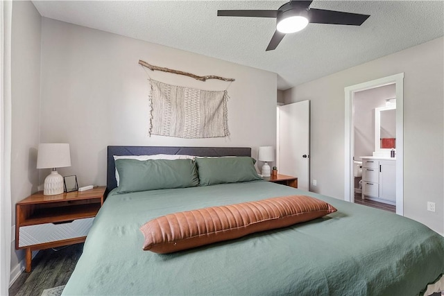 2905 NE 12th St, Bentonville, AR 72712 - bedroom featuring wood finished floors, a textured ceiling, ensuite bathroom, and a ceiling fan