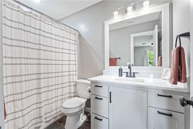 2905 NE 12th St, Bentonville, AR 72712 - full bathroom with vanity, wood finished floors, a shower with curtain, and a textured ceiling