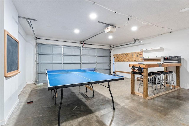 2905 NE 12th St, Bentonville, AR 72712 - rec room with a garage, concrete floors, and recessed lighting