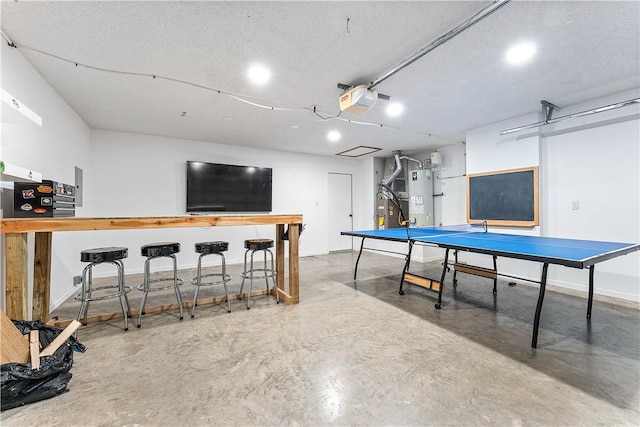 2905 NE 12th St, Bentonville, AR 72712 - playroom with concrete flooring, water heater, and recessed lighting