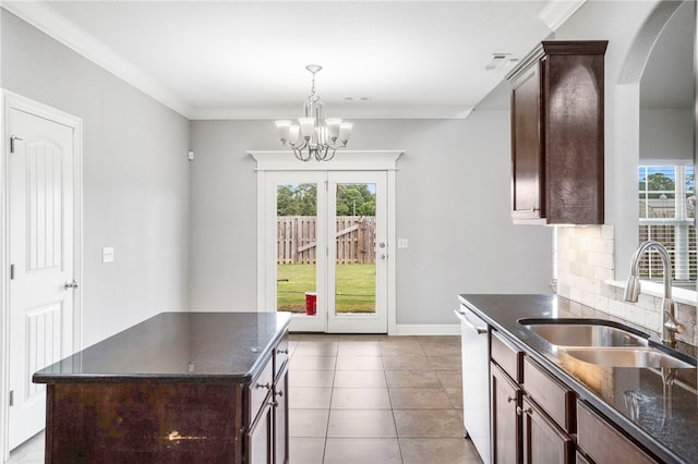 3915 Baltic St, Springdale, AR 72762 - kitchen featuring a chandelier, decorative backsplash, dishwasher, arched walkways, and decorative light fixtures