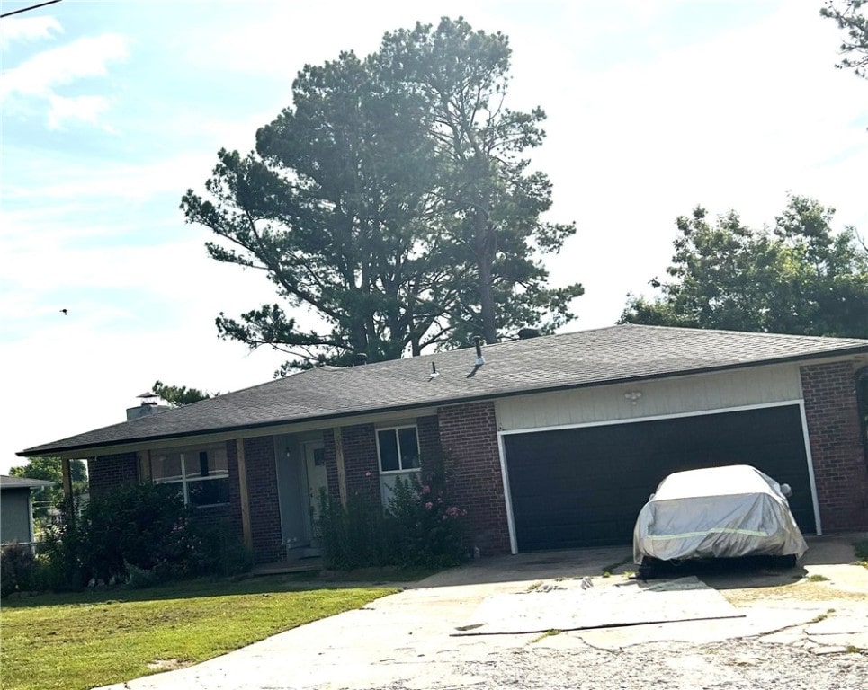 2305 S 16th St, Rogers, AR 72758 - single story home with brick siding, a garage, driveway, and a front lawn