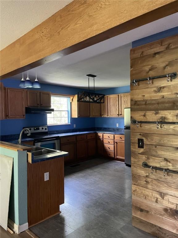 80 County Road 2560, Eureka Springs, AR 72631 - kitchen featuring under cabinet range hood, appliances with stainless steel finishes, a chandelier, dark countertops, and hanging light fixtures
