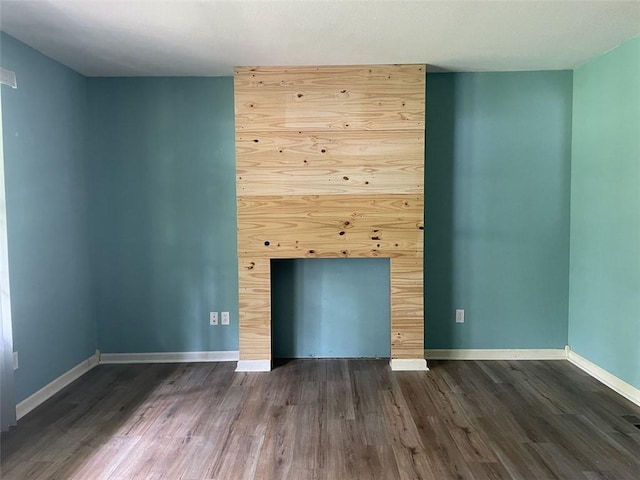 80 County Road 2560, Eureka Springs, AR 72631 - unfurnished living room featuring dark wood-style flooring and baseboards