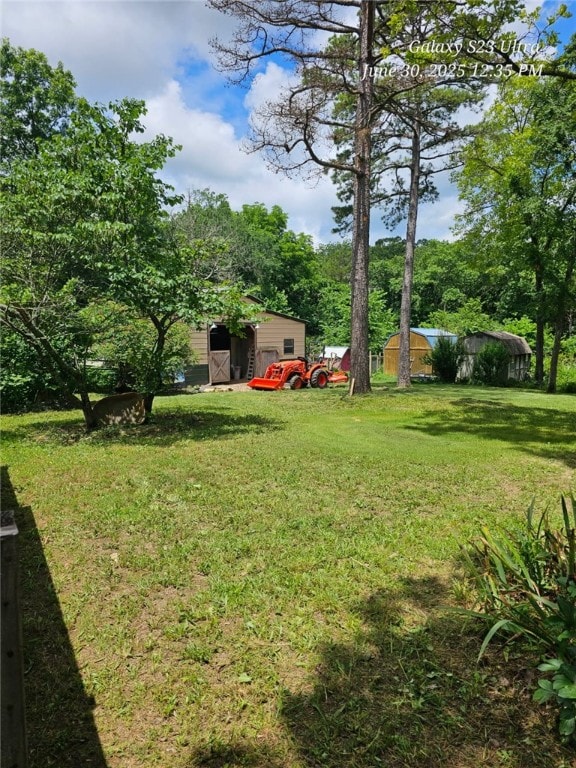 80 County Road 2560, Eureka Springs, AR 72631 - view of green lawn featuring view of wooded area and an outdoor structure