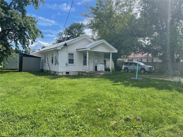 103 W 8th St, Green Forest, AR 72638 - back of house featuring covered porch and an outdoor structure