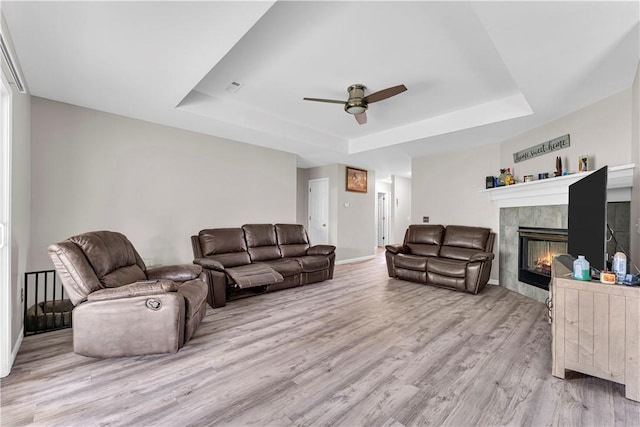 2317 SW Morris St, Bentonville, AR 72712 - living area featuring a raised ceiling, wood finished floors, ceiling fan, and a fireplace