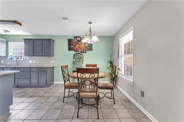 2317 SW Morris St, Bentonville, AR 72712 - dining space featuring a chandelier and light tile patterned flooring