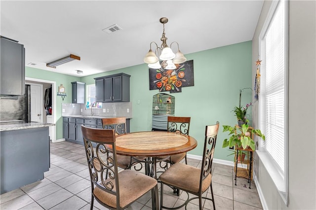 2317 SW Morris St, Bentonville, AR 72712 - dining space featuring light tile patterned floors, plenty of natural light, and a chandelier