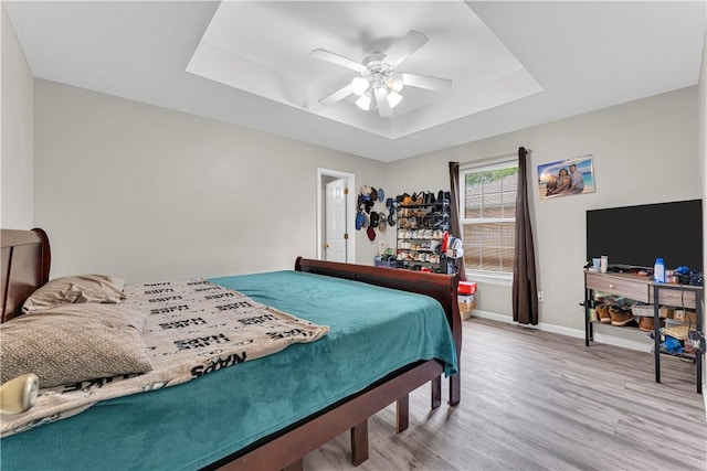 2317 SW Morris St, Bentonville, AR 72712 - bedroom featuring a raised ceiling, wood finished floors, and a ceiling fan
