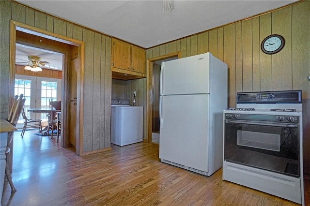 10746 Sr 27, Hector, AR 72843 - kitchen featuring white appliances, washer / dryer, wooden walls, light wood-type flooring, and a ceiling fan