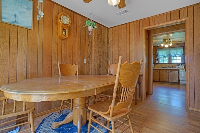 10746 Sr 27, Hector, AR 72843 - dining area with a ceiling fan, wooden walls, and wood finished floors