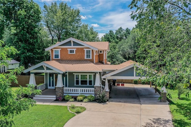 214 Lake Francis Dr, Siloam Springs, AR 72761 - craftsman house featuring driveway, covered porch, a carport, roof with shingles, and stone siding