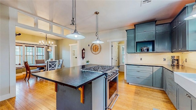 214 Lake Francis Dr, Siloam Springs, AR 72761 - kitchen with high end stove, a chandelier, light wood-type flooring, and decorative backsplash