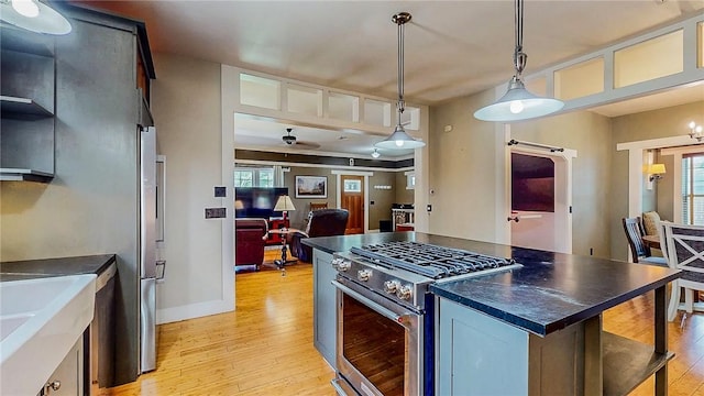 214 Lake Francis Dr, Siloam Springs, AR 72761 - kitchen with stainless steel appliances, dark countertops, light wood-style flooring, and healthy amount of natural light