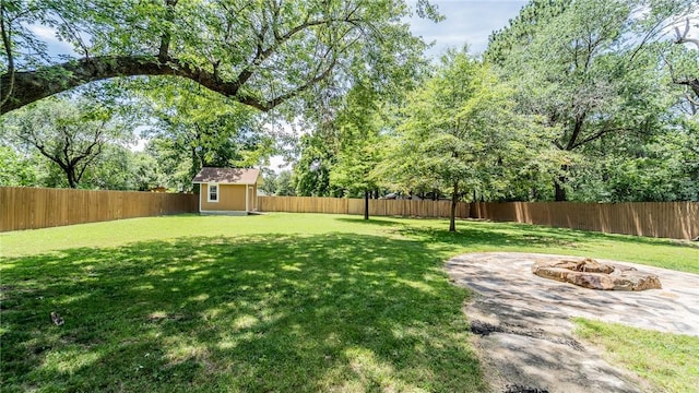 214 Lake Francis Dr, Siloam Springs, AR 72761 - fenced backyard featuring a fire pit and a storage shed