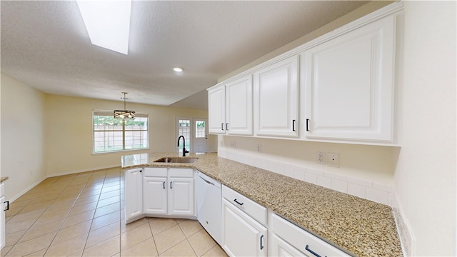 1142 S Jasmine Ln, Fayetteville, AR 72704 - kitchen with white dishwasher, a peninsula, white cabinets, light tile patterned flooring, and light stone counters