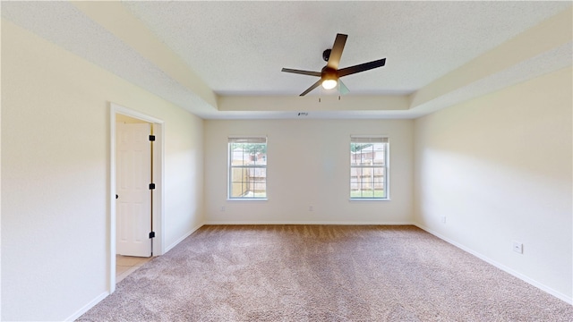 1142 S Jasmine Ln, Fayetteville, AR 72704 - unfurnished room with light colored carpet, a ceiling fan, a tray ceiling, and a textured ceiling