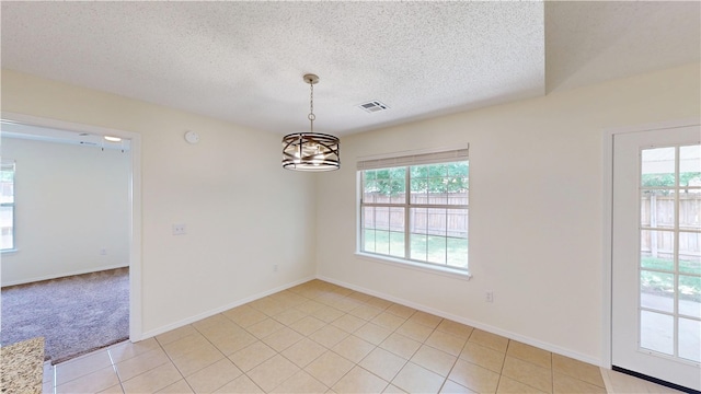 1142 S Jasmine Ln, Fayetteville, AR 72704 - spare room featuring a textured ceiling, a chandelier, and light tile patterned floors