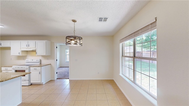 1142 S Jasmine Ln, Fayetteville, AR 72704 - kitchen featuring white electric range oven, under cabinet range hood, plenty of natural light, a textured ceiling, and white cabinetry