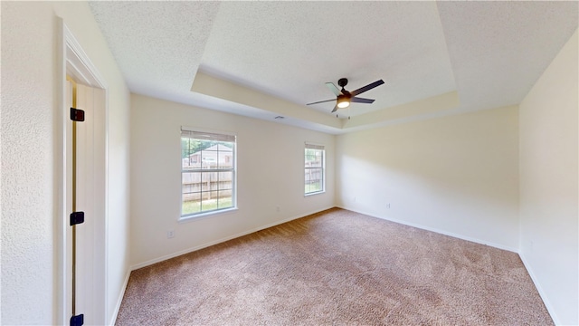 1142 S Jasmine Ln, Fayetteville, AR 72704 - spare room with a raised ceiling, a ceiling fan, carpet, and a textured ceiling