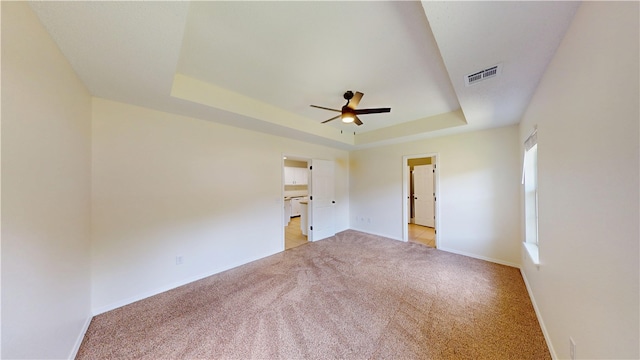 1142 S Jasmine Ln, Fayetteville, AR 72704 - unfurnished bedroom with a raised ceiling, light colored carpet, and a ceiling fan
